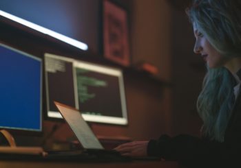 Free Side View of a Woman Using a Laptop Stock Photo