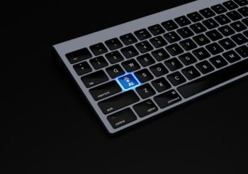 a black keyboard with a blue button on it