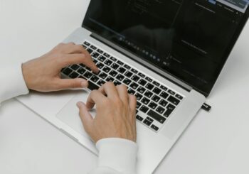 Free Hands on a Laptop Keyboard Stock Photo