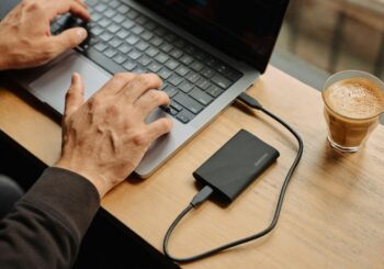 A man sitting at a table using a laptop computer